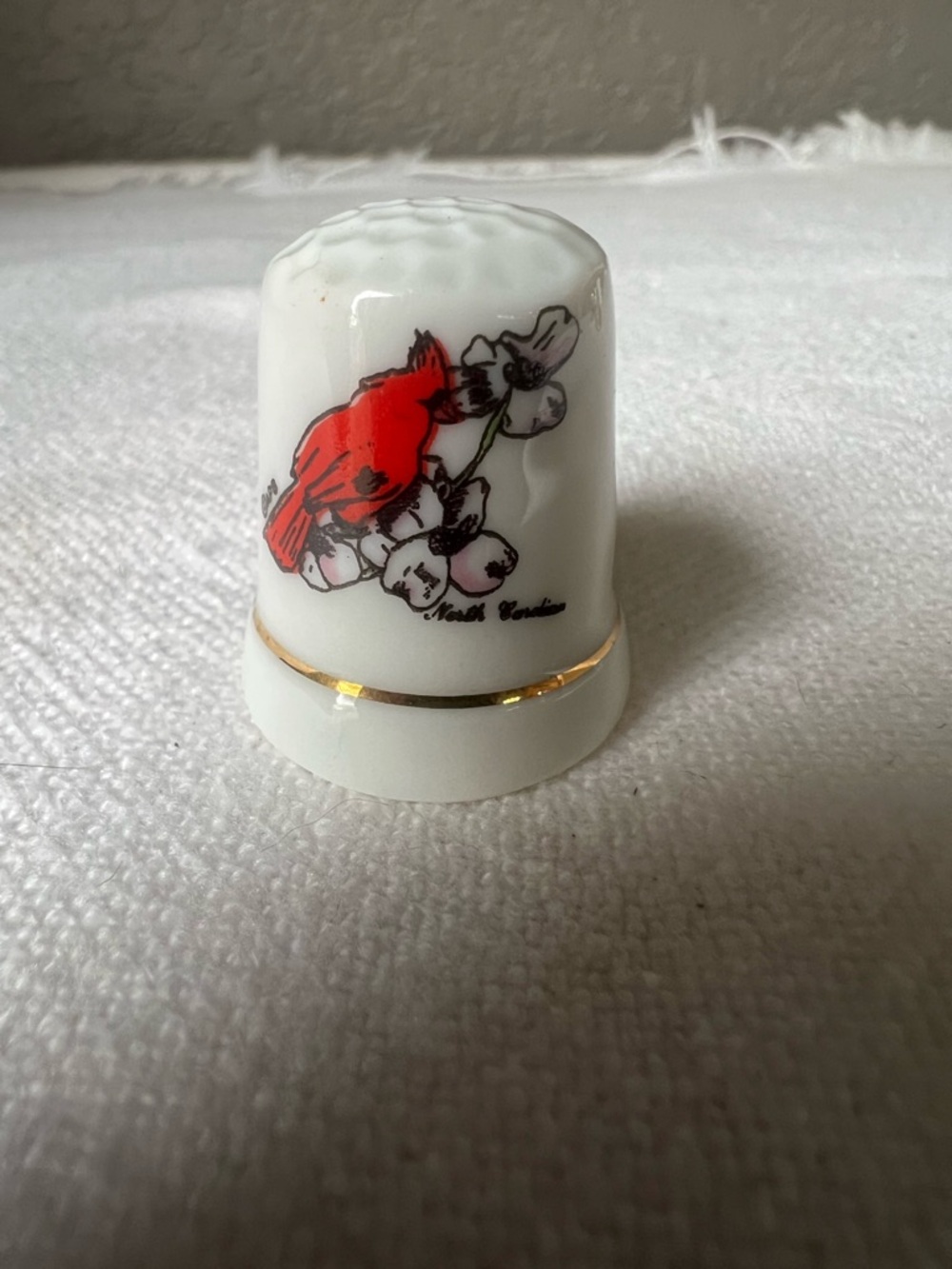 vintage, porcelain souvenir thimble featuring a hand-painted red cardinal